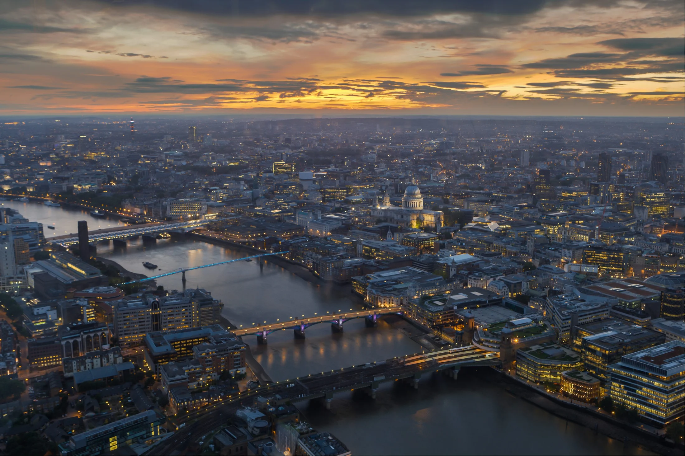 Aerial view of London's skyline and the River Thames at sunset